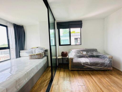 spacious bedroom with large window and mirrored closet