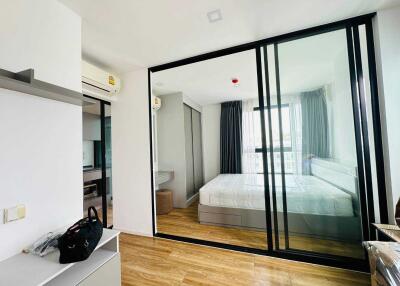 Modern bedroom with hardwood floors and glass wall partition