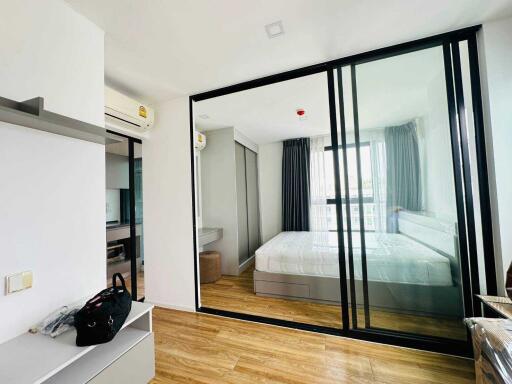 Modern bedroom with hardwood floors and glass wall partition