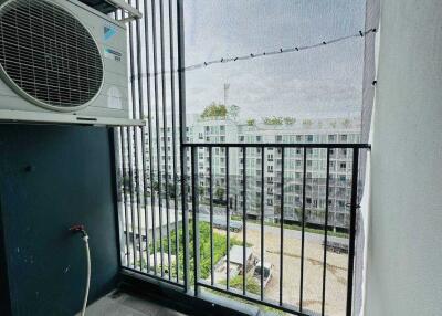 Balcony with air-conditioning units and apartment building view