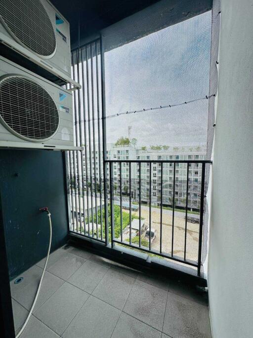 Balcony with air-conditioning units and apartment building view