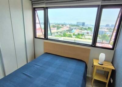 Bedroom with blue bedspread and city view