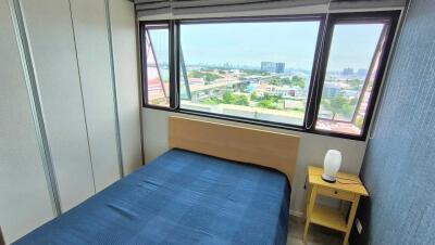 Bedroom with blue bedspread and city view