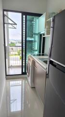 Laundry room with washer and refrigerator