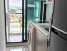 Laundry room with washer and refrigerator