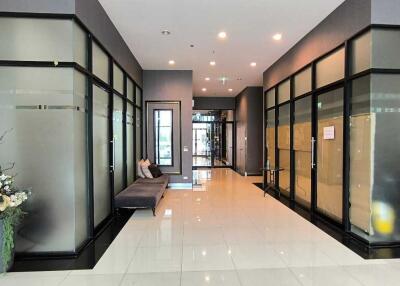 Modern building lobby with glass walls and seating area