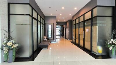 Modern building lobby with glass walls and seating area