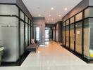 Modern building lobby with glass walls and seating area