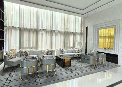 Luxurious modern living room with ceiling-to-floor windows and contemporary furnishings