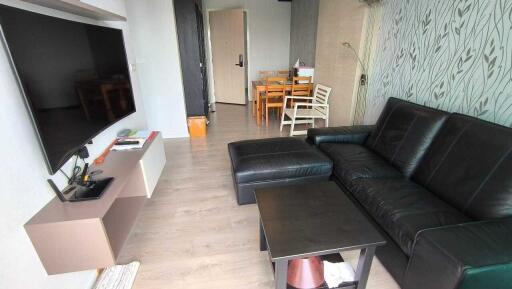 Living room with black leather sofa and modern decorations