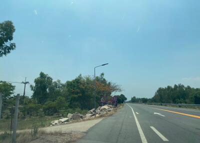 View of a road with trees and a sign