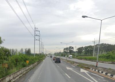 Two-lane road with vehicles and power lines