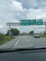 View of a road with directional signs to Rayong, Sattahip, and Pattaya