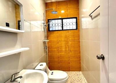 Bright modern bathroom with shower and window