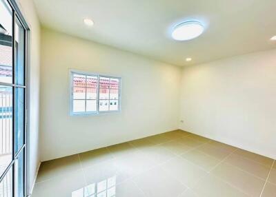 Empty room with tiled floor, three light fixtures, window, and sliding door