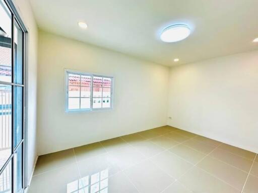 Empty room with tiled floor, three light fixtures, window, and sliding door