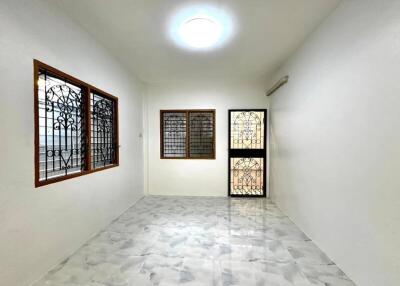 Minimalistic living room with marble flooring and large windows