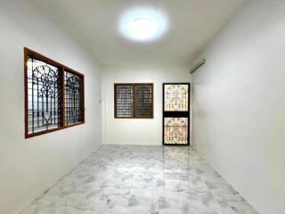 Minimalistic living room with marble flooring and large windows