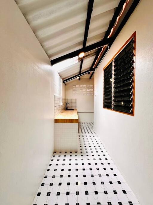 Narrow kitchen space with tiled floor and minimalist design