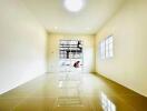 Bright and clean living area with large window and tiled floor