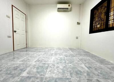 Unfurnished empty room with tiled floor and an air conditioner