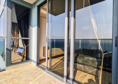 Balcony with glass doors and ocean view