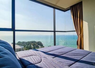 Bedroom with large windows offering a stunning ocean view