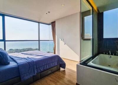 Modern bedroom with large windows and a scenic view