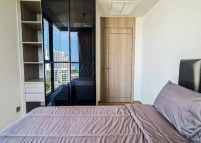 modern bedroom with large window and built-in wardrobe