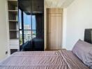 modern bedroom with large window and built-in wardrobe