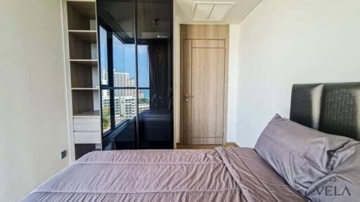 modern bedroom with large window and built-in wardrobe
