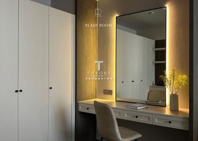 Bedroom with illuminated vanity and built-in wardrobe