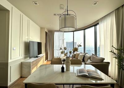 A modern and well-lit living room with a dining area