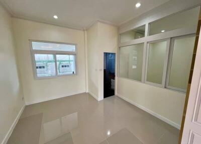 Empty room with ceramic tile flooring and large windows