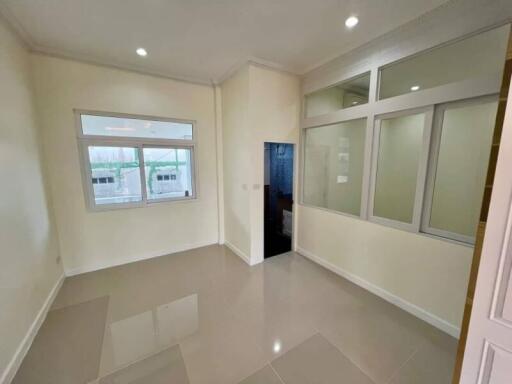 Empty room with ceramic tile flooring and large windows