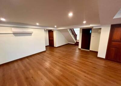 Spacious living room with wood flooring and recessed lighting