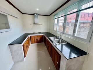 Modern kitchen with large windows and black countertops