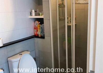 Bathroom with toilet and shower area