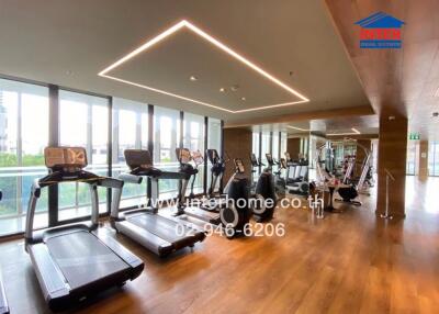 Fitness center with modern exercise equipment and floor-to-ceiling windows