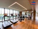 Fitness center with modern exercise equipment and floor-to-ceiling windows