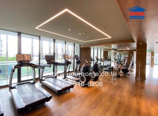 Fitness center with modern exercise equipment and floor-to-ceiling windows