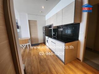 Modern kitchen with wooden floor and built-in appliances