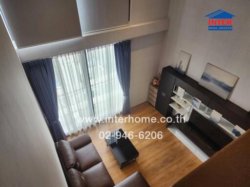 Spacious living room with a view of the balcony