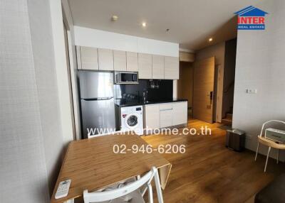 Modern kitchen and dining area with wooden flooring