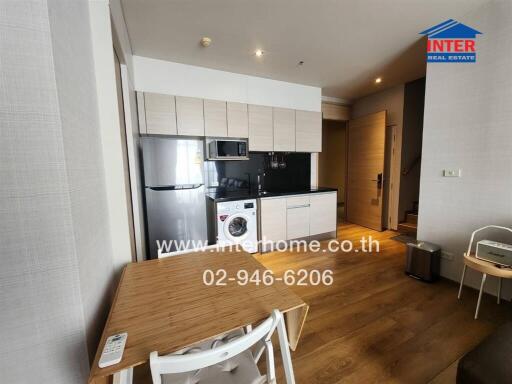 Modern kitchen and dining area with wooden flooring