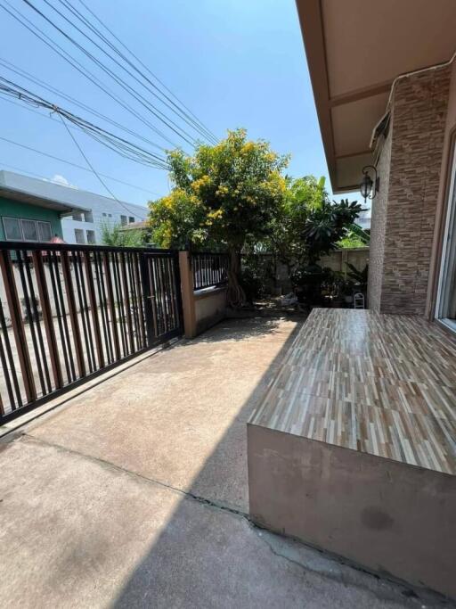 Well-maintained front yard with paved area and greenery