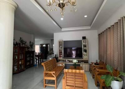 Spacious living room with chandelier and wooden furniture