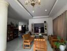 Spacious living room with chandelier and wooden furniture