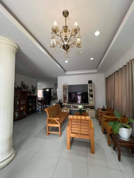 Spacious living room with chandelier and wooden furniture