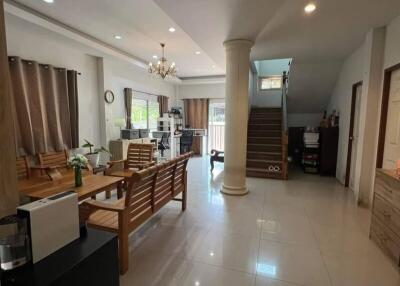 Spacious living room with modern furnishings and staircase